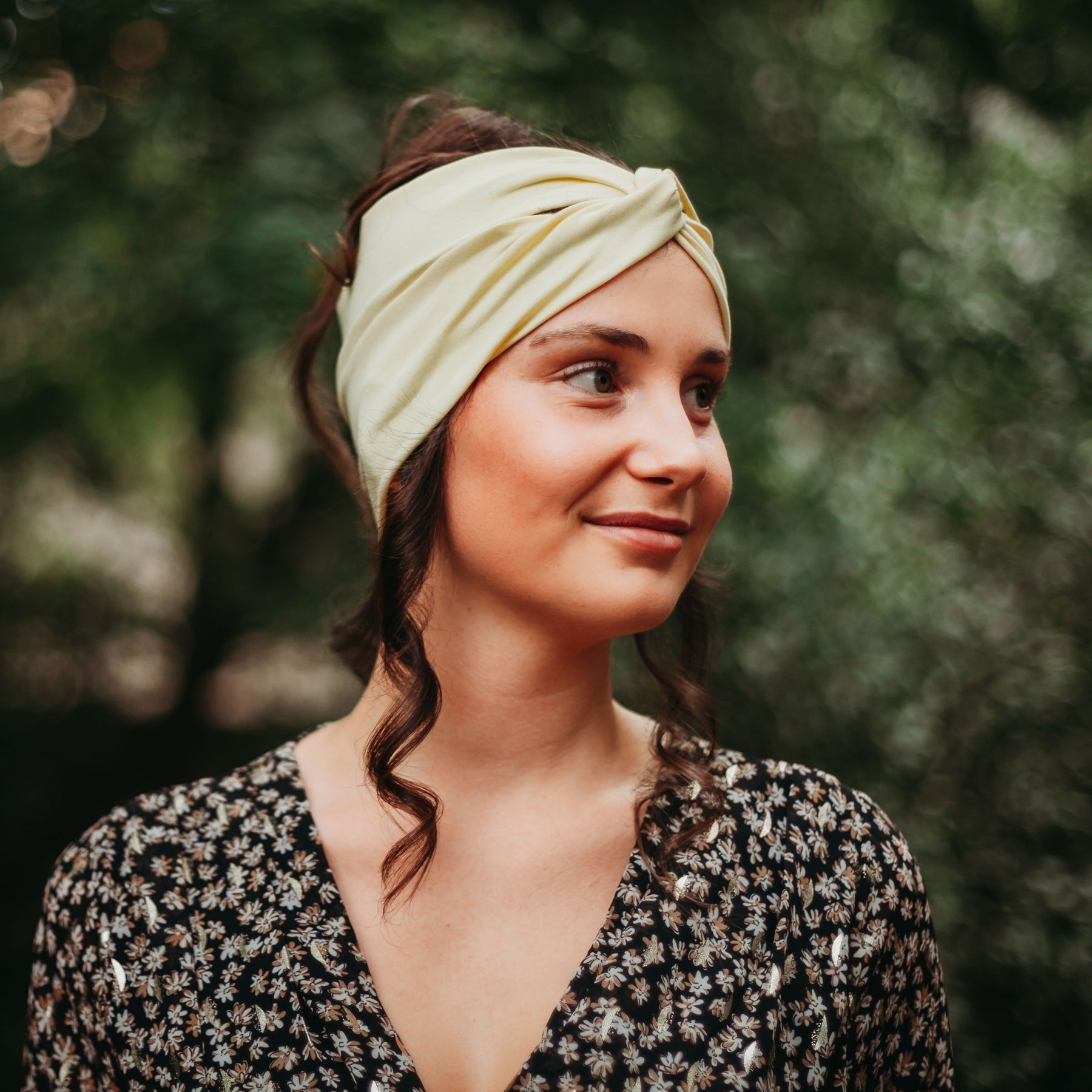 FEMME VUE DE PROFIL PORTANT UN CHIGNON ET UN BANDEAU JAUNE EN COTON BIOLOGIQUE